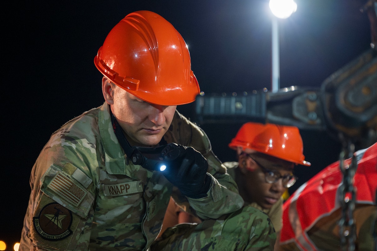U.S. Air Force Master Sgt. Trevor Knapp, 35th Civil Engineer Squadron first sergeant, examines a new aircraft arresting system as it is installed at Misawa Air Base, Japan, Aug. 19, 2025.