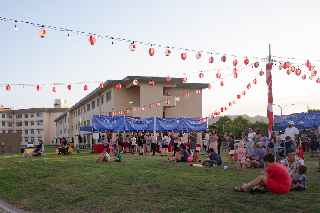 Attendees enjoy the food and festivities of the Bon Odori festival at Marine Corps Air Station Iwakuni, Japan, August 16, 2025. This festival was hosted on MCAS Iwakuni to bring communities together by honoring the spirits of one’s ancestors. (U.S. Marine Corps photo by Lance Cpl. Ella Cadby)