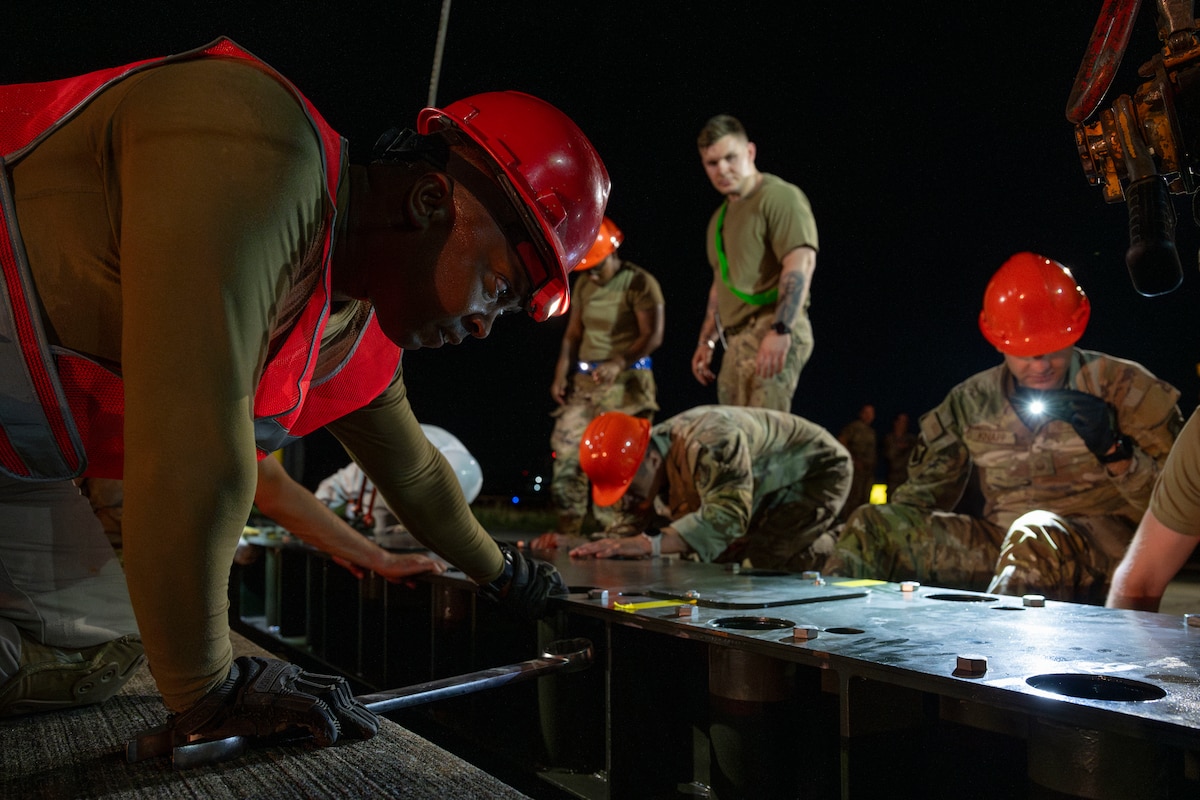 U.S. Air Force Airmen assigned to the 35th Civil Engineer Squadron work to install a new aircraft arresting system at Misawa Air Base, Japan, Aug. 19, 2025.