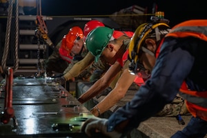 U.S. Air Force Airmen assigned to the 35th Civil Engineer Squadron and contractors work to set a new aircraft arresting system in place at Misawa Air Base, Japan, Aug. 19, 2025.
