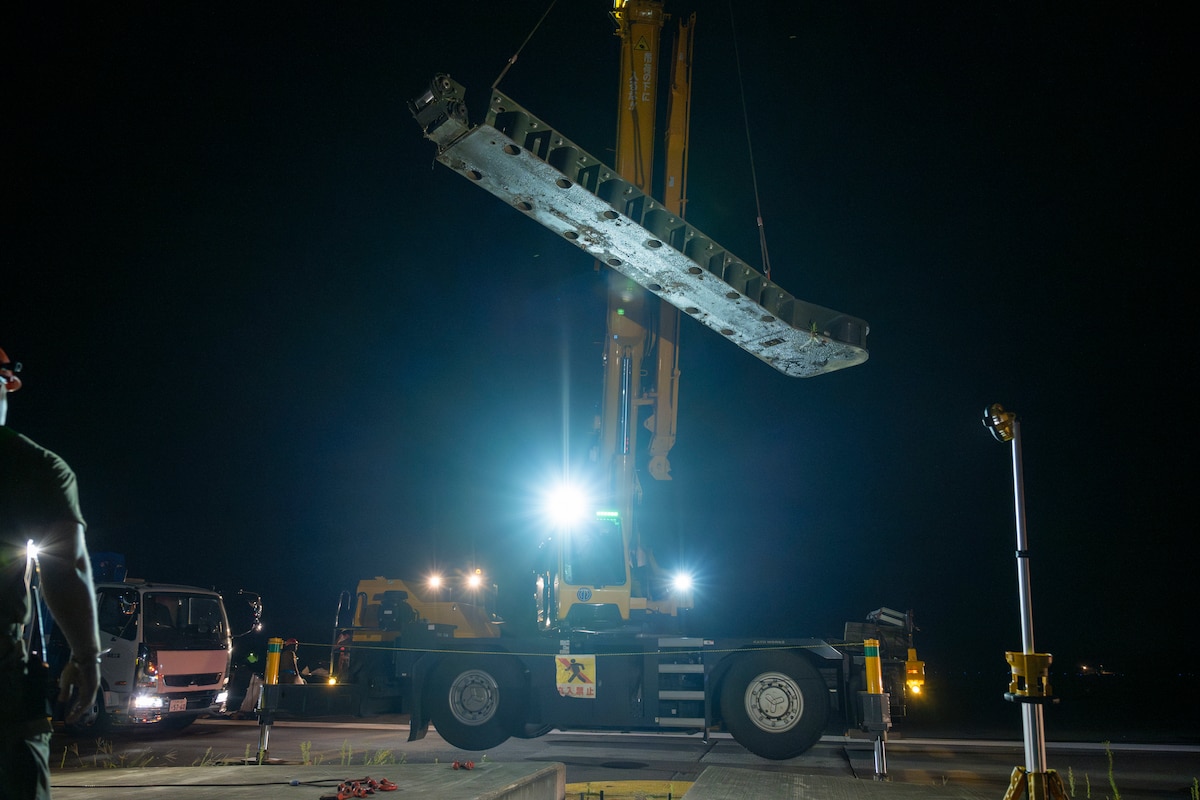 A crane lifts away an old aircraft arresting system to be replaced at Misawa Air Base, Japan, Aug. 19, 2025.