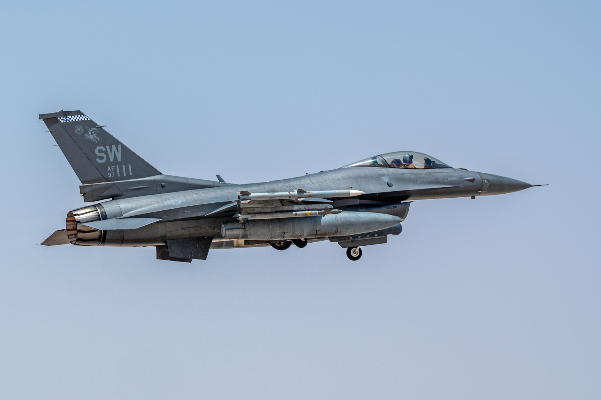 A U.S. Air Force F-16 Fighting Falcon assigned to the 55th Expeditionary Fighter Squadron retracts its landing gear after take off.