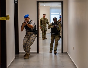 U.S. and Turkish Air Force personnel advance through a hallway during an active shooter exercise at Incirlik Air Base, Türkiye, Aug. 19, 2025.