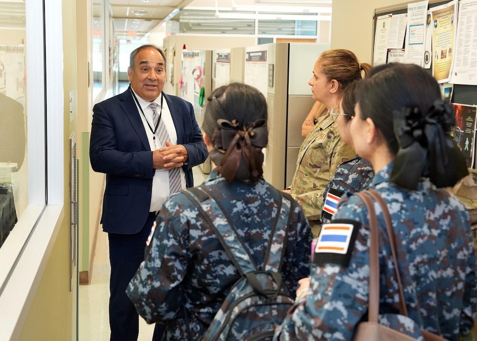 JOINT BASE SAN ANTONIO-FORT SAM HOUSTON – (Aug. 14, 2025) – Dr. Darrin Frye, chief science director, Naval Medical Research Unit (NAMRU) San Antonio, gives a tour of research facilities to flight nurses from the Royal Thai Air Force at the Battlefield Health and Trauma Research Institute. The nurses visited medical commands within Joint Base San Antonio to enhance their nursing knowledge and skills to include advancing quality of nursing practice related to disease management. Navy Medicine Research & Development (NMR&D) contributes directly to positive working relationships with partner nation militaries, keeping the scope of Department of Defense capabilities wide, and at the ready, to address emerging threats aboard. NAMRU San Antonio, part of NMR&D, conducts gap-driven combat casualty care, craniofacial, and directed energy research in support of Navy, Marine Corps and joint U.S. warfighter health readiness and lethality while engaged in routine and expeditionary operations. (U.S. Navy photo by Burrell Parmer, NAMRU San Antonio Public Affairs/Released)