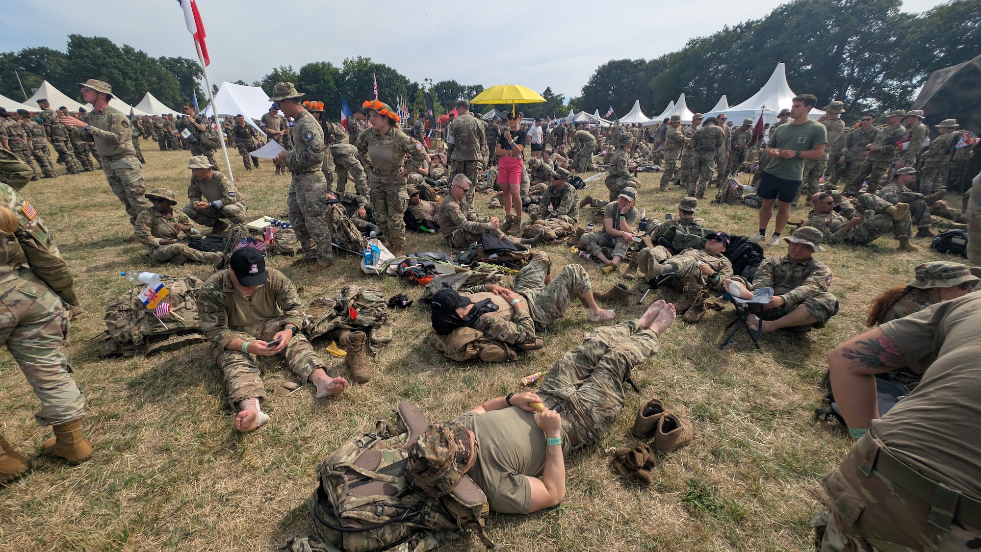 U.S. Airmen from 1st Combat Communications Squadron take a break during a 4-day ruck march across 106 miles in the Netherlands, July 15-18, 2025.