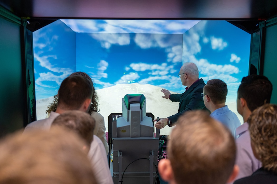 Vistors for the Ohio Staff Delegates Tour get a look inside a flight simulator at the Air Force Research Laboratory during their visit to Wright-Patterson Air Force Base, Aug. 5, 2025. Congressional Staff Delegations (STAFFDELs) tours provide insight to different organizations on the base for better knowledge and understanding of operations.