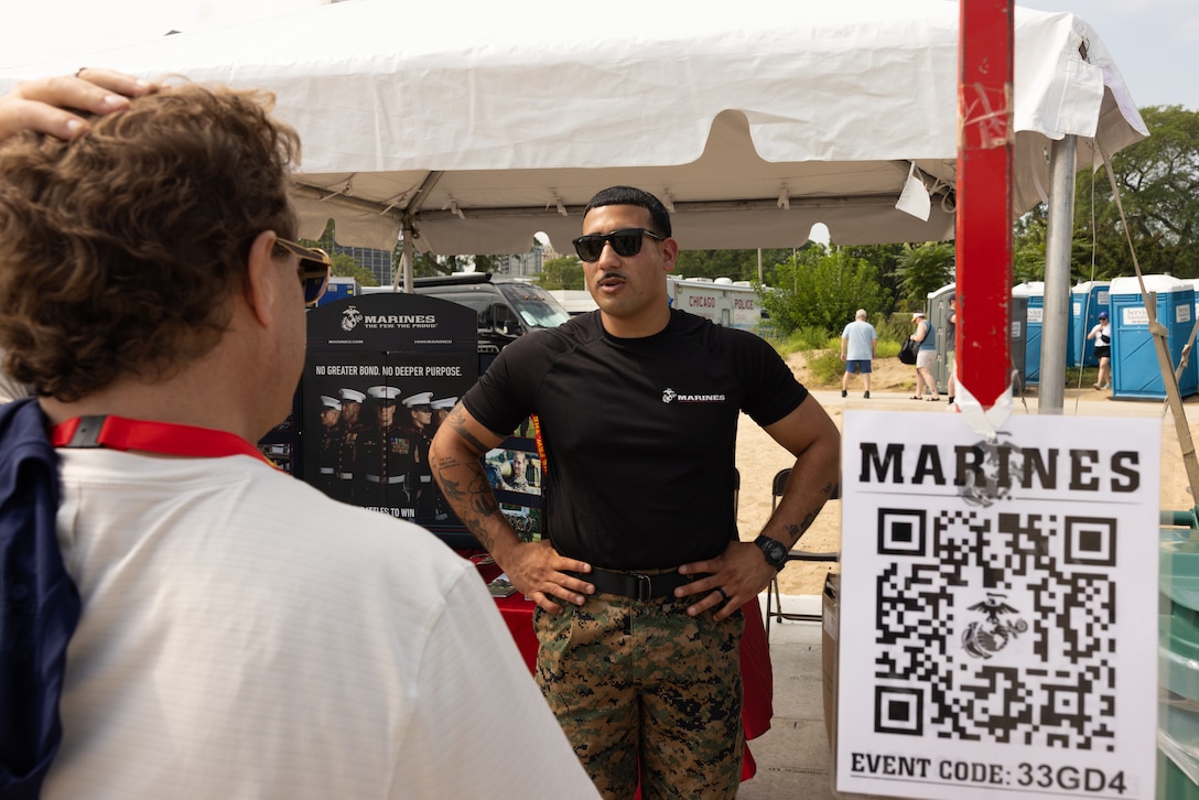 U.S. Marine Corps Sgt. Kevin Ghali, a recruiter with Recruiting Station South Chicago, interacts with event attendees during the Chicago Air and Water Show, in Chicago, Illinois, August 15, 2025. The Marines attended the Chicago Air and Water Show in support of community relations and recruiting efforts. The Chicago Air and Water Show presented by the City of Chicago is the largest free show of its kind in the United States. (U.S. Marine Corps photo by Lance Cpl. Kayla Goldman)