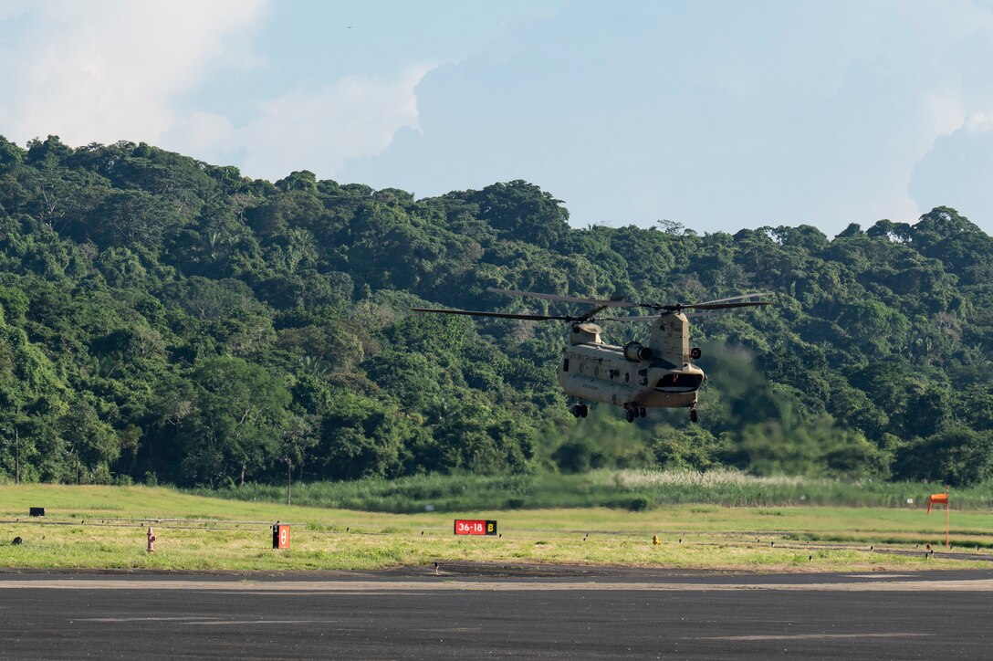 A CH-47 Chinook assigned to 1st Battalion, 228th Aviation Regiment, hovers prior to a training mission, during PANAMAX-Alpha Phase I, at Panama Pacifico International Airport, Panama, July 14, 2025. PANAMAX-Alpha Phase I is a government of Panama exercise supported by U.S. Southern Command, focused on security of the canal in Panama. The portion JTF-Bravo is participating in for phase 1 includes providing hot and cold load training, K-9 familiarization and hoist training, medical evacuation, fast rope insertion and aerial overwatch training with our helicopters and partners. (U.S. Air Force photo by Staff Sgt. Sadie Colbert)