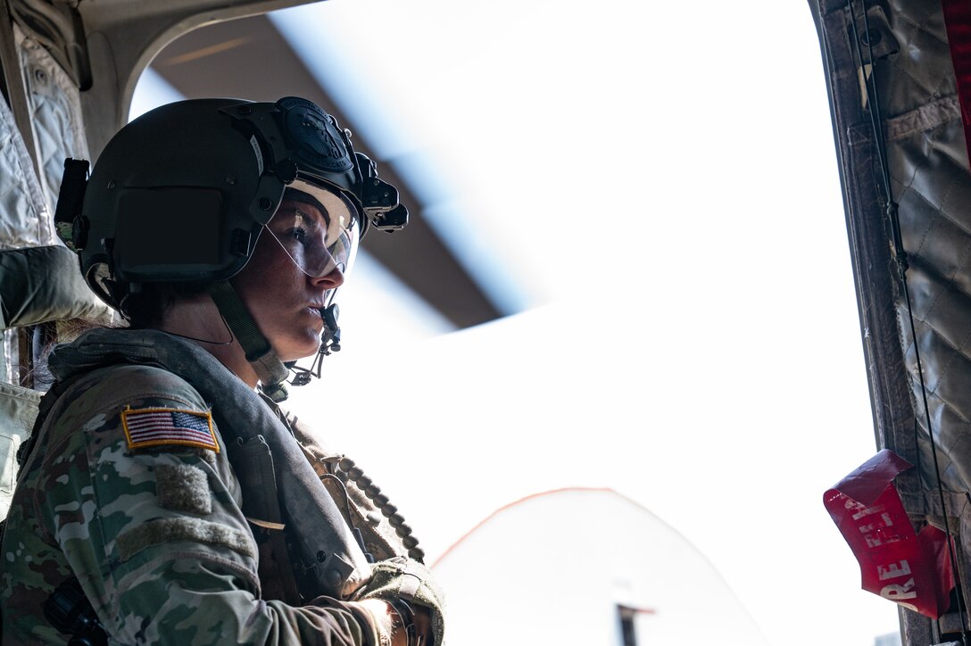 U.S. Army Staff Sgt. Bailea Parks, 1st Battalion, 228th Aviation Regiment aircrewman, sits in a CH-47 Chinook, during a training event at PANAMAX-Alpha Phase I, at Panama Pacifico International Airport, Panama, July 14, 2025. The U.S. and Panama have a longstanding partnership built on mutual respect, shared values, and enduring cooperation that benefits both our nations. (U.S. Air Force photo illustration by Staff Sgt. Sadie Colbert)
