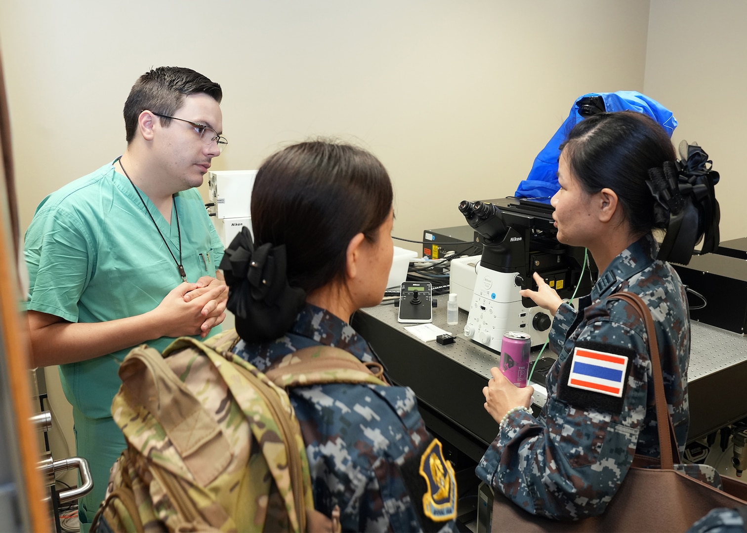 JOINT BASE SAN ANTONIO-FORT SAM HOUSTON – (Aug. 14, 2025) – Flight nurses from the Royal Thai Air Force speak with Dr. Daniel Thompson, a research scientist assigned to Naval Medical Research Unit (NAMRU) San Antonio’s Craniofacial Health and Restorative Medicine directorate, about a confocal microscope during a tour of laboratory facilities at the Battlefield Health and Trauma Research Institute. Four Royal Thai Air Force nurses visited medical commands within Joint Base San Antonio to enhance their nursing knowledge and skills to include advancing quality of nursing practice related to disease management. Navy Medicine Research & Development (NMR&D) contributes directly to positive working relationships with partner nation militaries, keeping the scope of Department of Defense capabilities wide, and at the ready, to address emerging threats aboard. NAMRU San Antonio, part of NMR&D, conducts gap-driven combat casualty care, craniofacial, and directed energy research in support of Navy, Marine Corps and joint U.S. warfighter health readiness and lethality while engaged in routine and expeditionary operations. (U.S. Navy photo by Burrell Parmer, NAMRU San Antonio Public Affairs/Released)