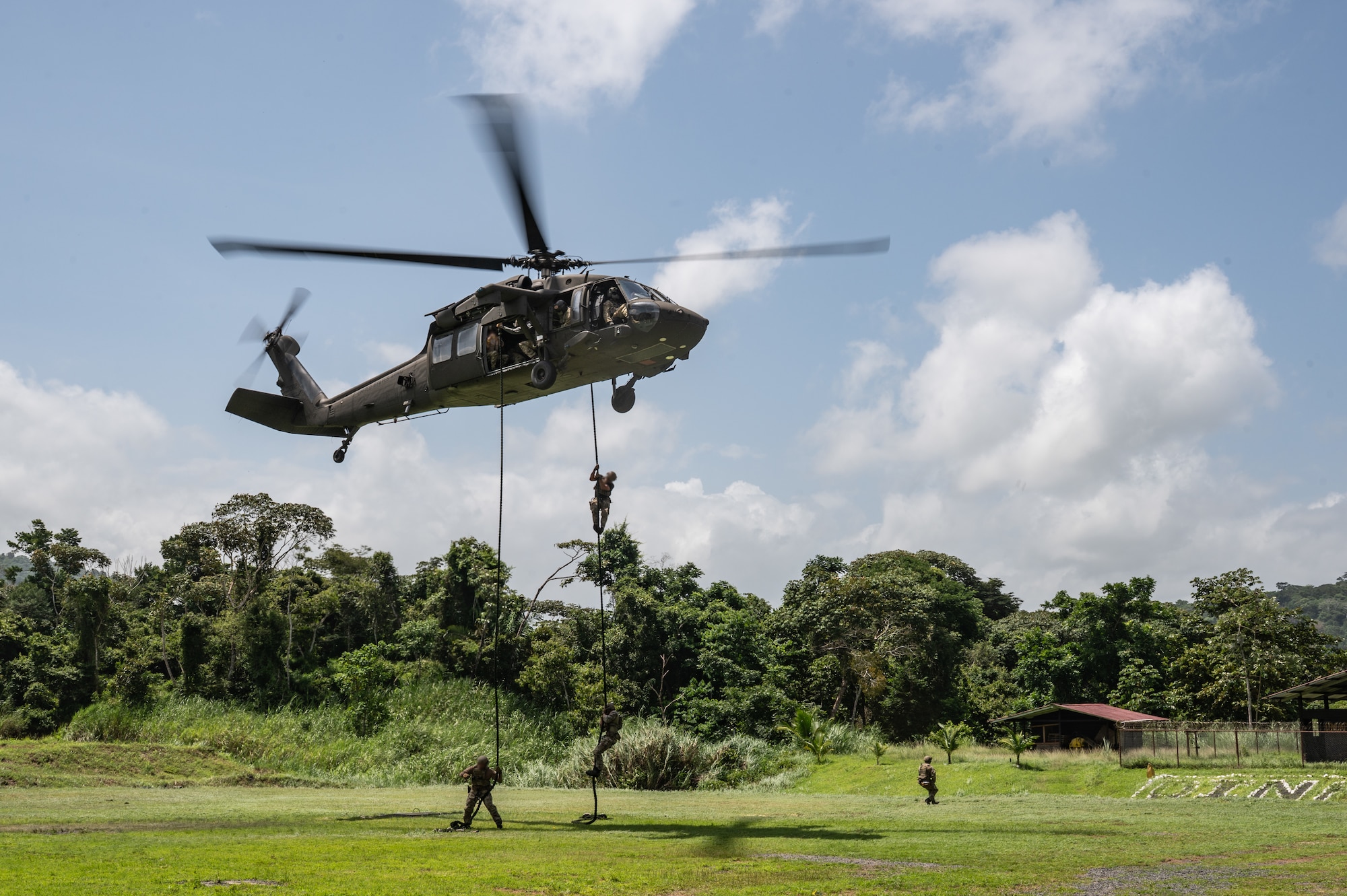 U.S. Naval Special Warfare operators and Panamanian special forces fast-rope down from a UH-60 Blackhawk during PANAMAX-Alpha Phase I, at Cerro Tigre, Panama, July 15, 2025. PANAMAX is a joint exercise designed to enhance interoperability among participating nations and strengthen their ability to conduct multinational operations, particularly to defend the Panama Canal. (U.S. Air Force photo by Staff Sgt. Sadie Colbert)