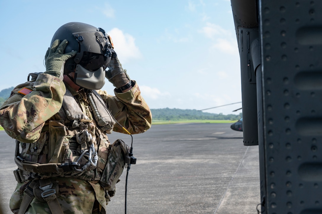 U.S. Army Sgt. Conor Beattie, 1st Battalion, 228th Aviation Regiment crew chief, dons his flight helmet during PANAMAX-Alpha Phase I, at Panama Pacifico International Airport, Panama, July 15, 2025. The U.S. and Panama have a longstanding partnership built on mutual respect, shared values, and enduring cooperation that benefits both our nations. (U.S. Air Force photo by Staff Sgt. Sadie Colbert)