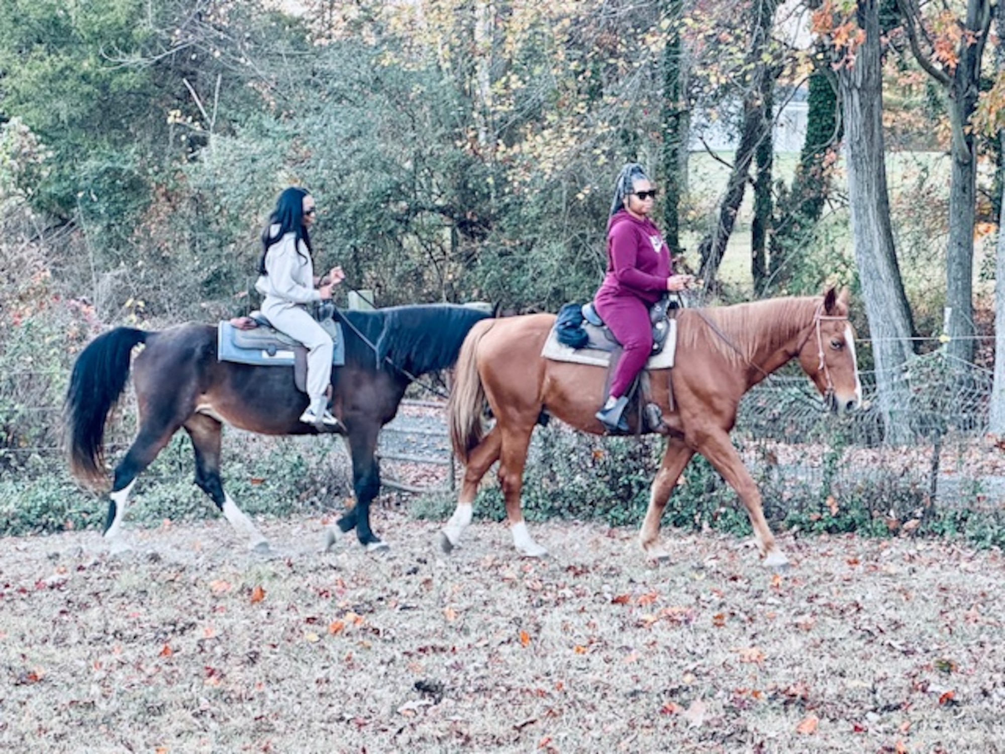 Jasmine McKinney, left, a defense enrollment eligibility reporting system technician with the 11th Force Support Squadron, rides a horse with her sister, Jacqueela Mason, right, during a horseback riding session in Waldorf, Maryland in fall 2024. Retired U.S. Air Force Chief Master Sgt. Fredrick Edison, deputy director for the Military Personnel Flight with the11th FSS, created his horseback riding mission, Freddy’s Heavenly Gaits, to support wellness for Airmen. (U.S. Air Force courtesy photo)