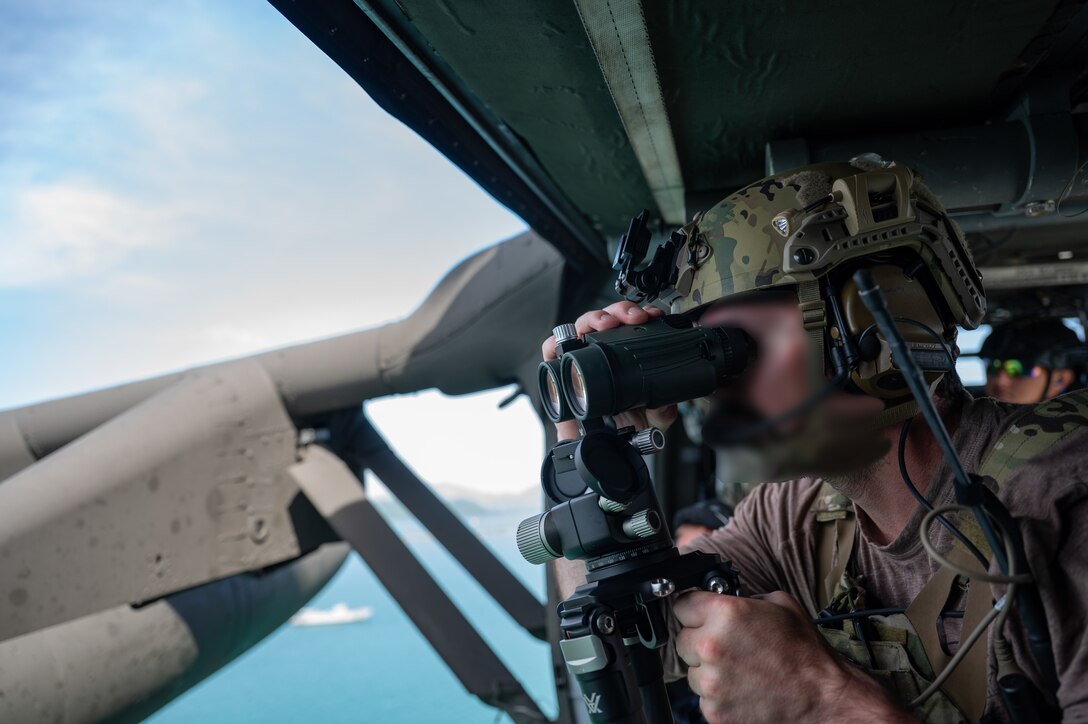 A U.S. Naval Special Warfare operator looks through binoculars, during PANAMAX-Alpha Phase I, at Panama City, Panama, July 16, 2025. PANAMAX is a joint exercise designed to enhance interoperability among participating nations and strengthen their ability to conduct multinational operations, particularly to defend the Panama Canal. (U.S. Air Force photo by Staff Sgt. Sadie Colbert)