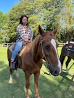 U.S. Air Force Staff Sgt. Karla Monroy, the noncommissioned officer in charge of The U.S. Air Force Band Commander’s Support Staff, participates in a horseback riding session in Waldorf, Maryland in fall 2024. Retired Chief Master Sgt. Fredrick Edison, deputy director for the Military Personnel Flight with the 11th Force Support Squadron, created his horseback riding mission, Freddy’s Heavenly Gaits, to support wellness for Airmen. (U.S. Air Force courtesy photo)