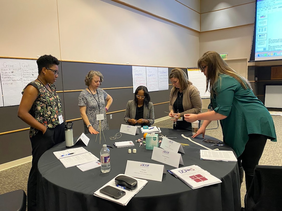 Defense Logistics Agency Aviation Lead Inventory Management Specialist Mearle Tilton, second from right, participates in a team building exercise with her peers at the Defense Civilian Emerging Leader Program in Norman, Oklahoma