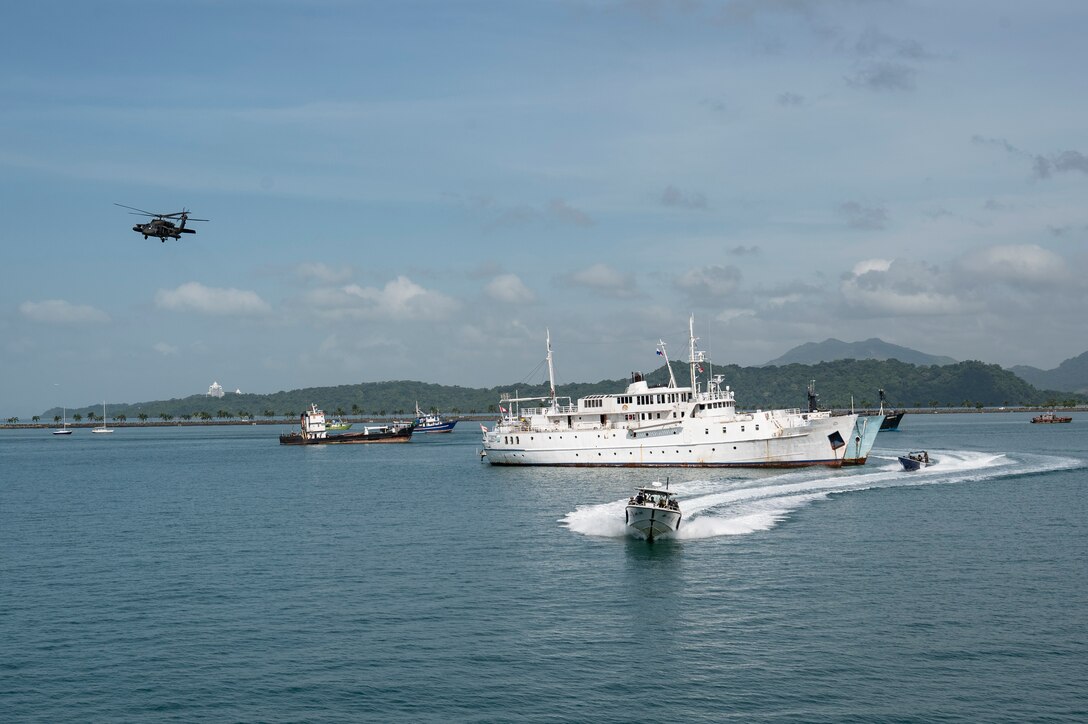 A UH-60 Blackhawk, assigned to the 1-228th Aviation Regiment out of Soto Cano Air Base, provides overhead support during a bilateral simulated visit, board, search, and seizure training between U.S. and Panamanian special forces units, at Panama City, Panama, July 17, 2025. PANAMAX is a joint exercise designed to enhance interoperability among participating nations and strengthen their ability to conduct multinational operations, particularly to defend the Panama Canal. (U.S. Air Force photo by Staff Sgt. Sadie Colbert)