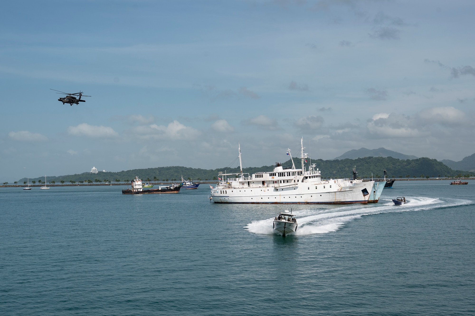 A UH-60 Blackhawk, assigned to the 1-228th Aviation Regiment out of Soto Cano Air Base, provides overhead support during a bilateral simulated visit, board, search, and seizure training between U.S. and Panamanian special forces units, at Panama City, Panama, July 17, 2025. PANAMAX is a joint exercise designed to enhance interoperability among participating nations and strengthen their ability to conduct multinational operations, particularly to defend the Panama Canal. (U.S. Air Force photo by Staff Sgt. Sadie Colbert)