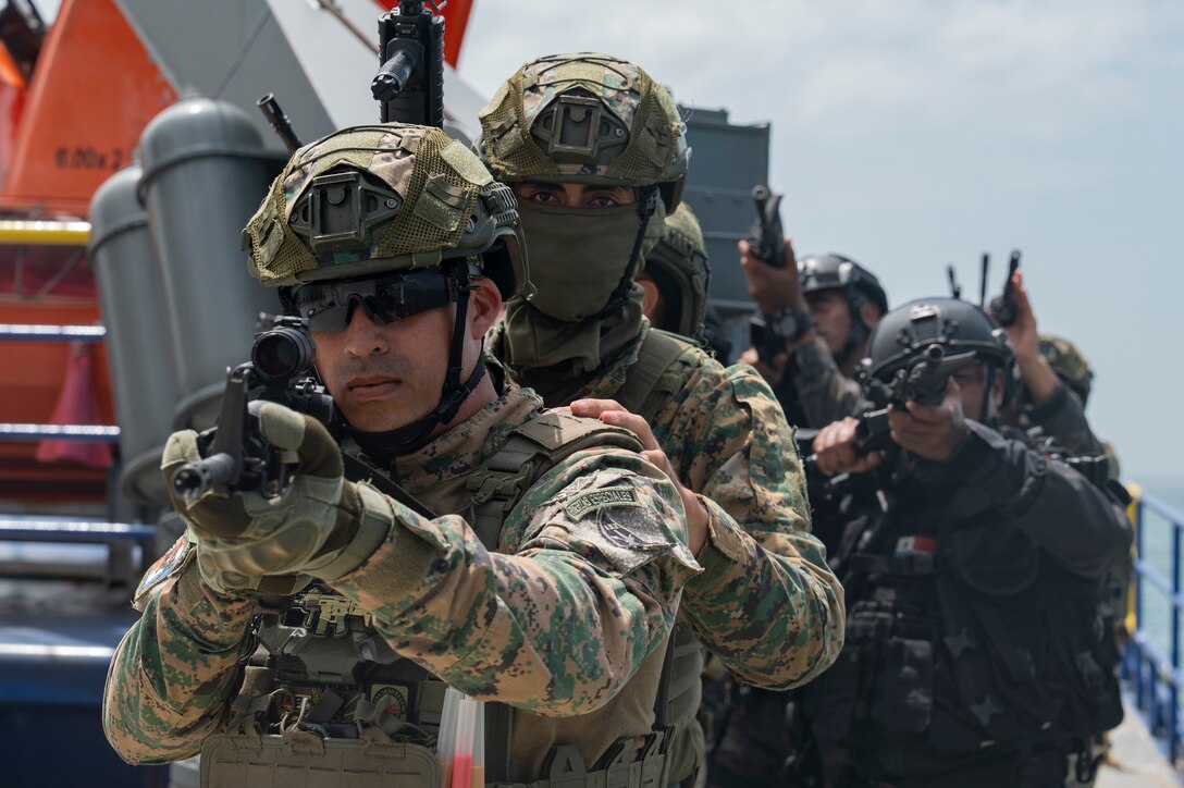 Panamanian special forces members prepare to search a vessel during a bilateral simulated visit, board, search, and seizure training with the U.S., at Panama City, Panama, July 17, 2025. As part of PANAMAX-Alpha Phase I, the Government of Panama conducted unilateral, simulated Panama Canal security operations, supported by U.S. Southern Command. This phase includes Military Decision-Making Process (MDMP) academics, a command post exercise (CPX), and a field training exercise (FTX). (U.S. Air Force photo by Staff Sgt. Sadie Colbert)