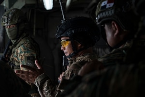 A Panamanian Servicio Nacionales de Fronteras (SENAFRONT) member motions his team to move forward during a simulated visit, board, search, and seizure training between U.S. and Panamanian special forces units, at Panama City, Panama, July 17, 2025. As part of PANAMAX-Alpha Phase I, the Government of Panama conducted unilateral, simulated Panama Canal security operations, supported by U.S. Southern Command. This phase includes Military Decision-Making Process (MDMP) academics, a command post exercise (CPX), and a field training exercise (FTX). (U.S. Air Force photo by Staff Sgt. Sadie Colbert)