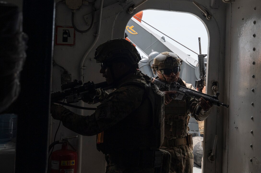 Two Panamanian Servicio Nacionales de Fronteras (SENAFRONT) members clear a room during a simulated visit, board, search, and seizure training between U.S. and Panamanian special forces units, at Panama City, Panama, July 17, 2025. As part of PANAMAX-Alpha Phase I, the Government of Panama conducted unilateral, simulated Panama Canal security operations, supported by U.S. Southern Command. This phase includes Military Decision-Making Process (MDMP) academics, a command post exercise (CPX), and a field training exercise (FTX). (U.S. Air Force photo by Staff Sgt. Sadie Colbert)