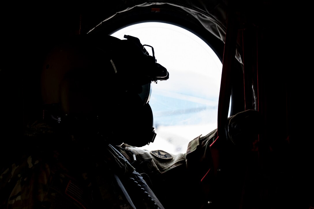 U.S. Army Sgt. Gabe Lucero, 1st Battalion, 228th Aviation Regiment crew chief, performs a flight observation in a CH-47 Chinook in Honduras, July 31, 2025. Given Central America's high vulnerability to natural disasters, Joint Task Force-Bravo's AGILE BEAR exercise works collaboratively with the British Army Training Support Unit-Belize, Belize Defence Force and Belize Coast Guard to conduct  subject matter expert exchanges equipping our forces with the necessary knowledge and resources to lessen the impact of these events. (U.S. Air Force photo by Staff Sgt. Sadie Colbert)
