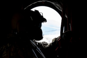 U.S. Army Sgt. Gabe Lucero, 1st Battalion, 228th Aviation Regiment crew chief, performs a flight observation in a CH-47 Chinook in Honduras, July 31, 2025. Given Central America's high vulnerability to natural disasters, Joint Task Force-Bravo's AGILE BEAR exercise works collaboratively with the British Army Training Support Unit-Belize, Belize Defence Force and Belize Coast Guard to conduct  subject matter expert exchanges equipping our forces with the necessary knowledge and resources to lessen the impact of these events. (U.S. Air Force photo by Staff Sgt. Sadie Colbert)