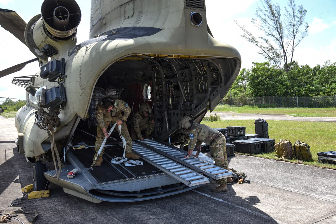 U.S. Army Soldiers, assigned to the 1st Battalion, 228 Aviation Regiment, out of Joint Task Force-Bravo, Soto Cano Air Base, Honduras, prepare to deload a CH-47 Chinook during AGILE BEAR 25, July 31, 2025. JTF-Bravo's helicopter activities, in collaboration with host nation and NATO military partners, showcase their unique ability to perform search and rescue operations and deliver humanitarian aid to remote environments. This demonstrates their support capabilities for communities affected by natural disasters. (U.S. Air Force photo by Tech. Sgt. Dylan Rossitto)