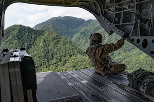 U.S. Army Sgt. Gabe Lucero, 1st Battalion, 228th Aviation Regiment crew chief, performs a flight observation in a CH-47 Chinook in Honduras, July 31, 2025. Joint Task Force-Bravo's helicopter activities, in collaboration with host nation and NATO military partners, showcase their unique ability to perform search and rescue operations and deliver humanitarian aid to remote environments. (U.S. Air Force photo by Staff Sgt. Sadie Colbert)