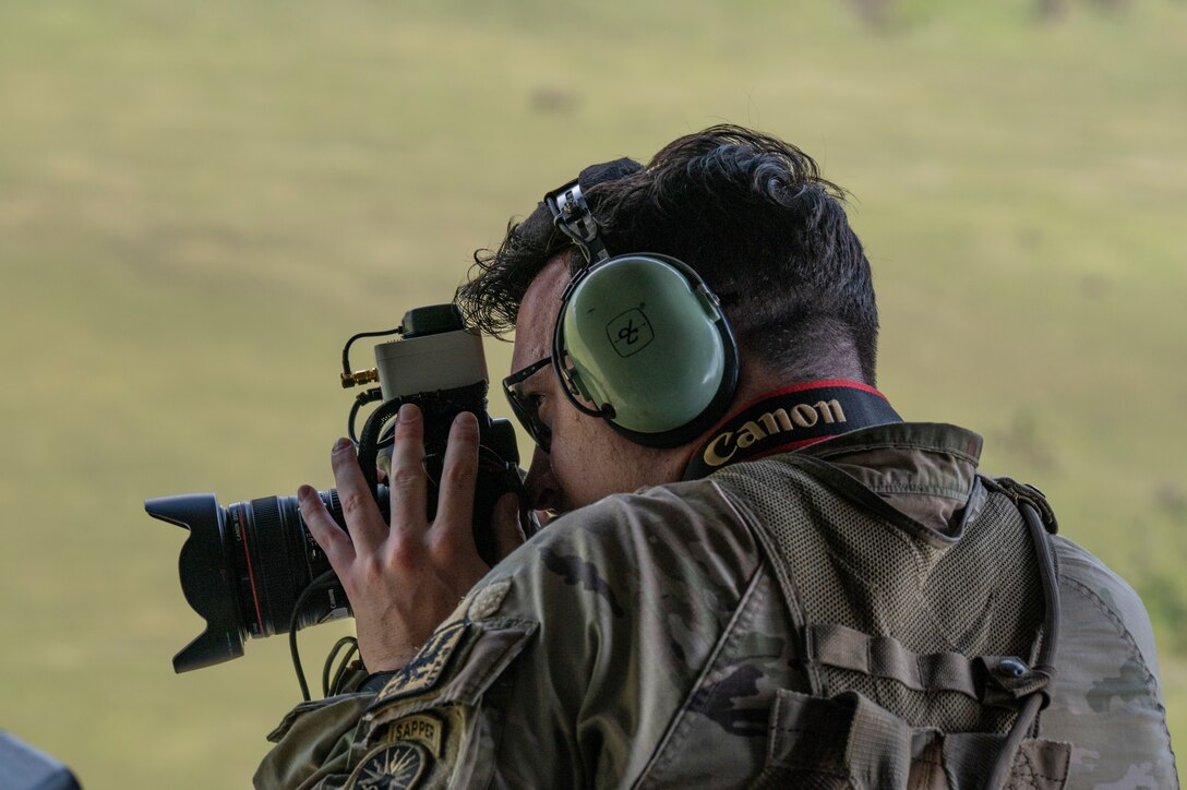 A U.S. Army  Joint Task Force-Bravo J7 member, takes a photo with an Automated Route Reconnaissance Kit (ARRK) in a CH-47 Chinook, in Belize, during exercise AGILE BEAR August 2, 2025. JTF-Bravo used the ARRK to collect data from illegal airstrips used for transnational criminal organization activities. AGILE BEAR, led by Joint Task Force-Bravo, provides critical subject matter expert exchanges, preparing U.S. Southern Command’s Situational Assessment Team, 1-228th Aviation Regiment, and Belize and NATO partners for a collaborative response in times of crises. (U.S. Air Force photo by Staff Sgt. Sadie Colbert)