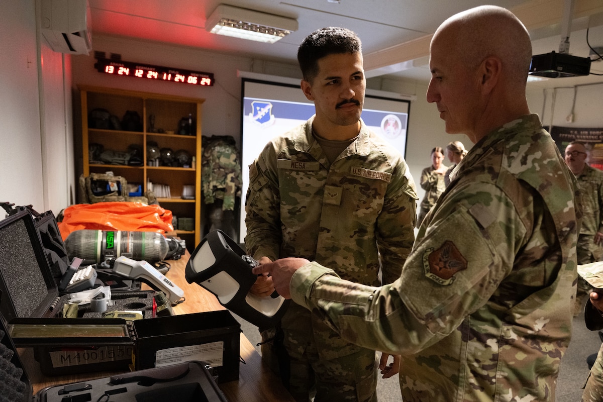 Chief Master Sgt. of the Air Force David Flosi, right, talks with Airman 1st Class James Mesa, 39th Civil Engineer Squadron emergency management apprentice, during his visit to Incirlik Air Base, Türkiye, August 14, 2025.