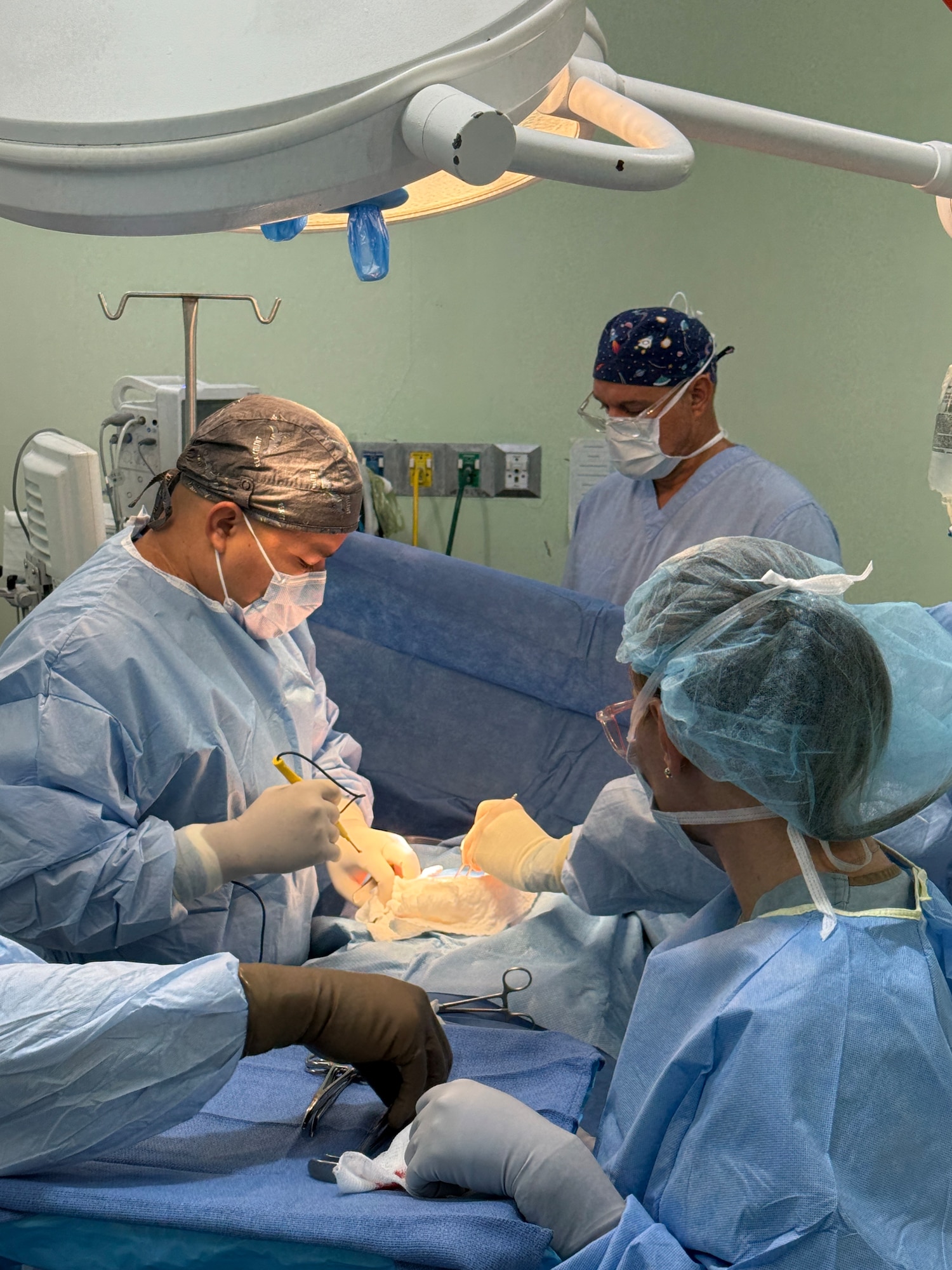 Belize surgeon, Dr. Zul, prepares to make his first incision along with Joint Task Force-Bravo members assisting in the gallbladder surgery, during a JTF-Bravo surgical mission, Belmopan, Belize, Aug. 5, 2025.Surgical missions provide an opportunity for servicemembers to engage with the local community and give back to our neighbors while providing them with services that may otherwise be unavailable or in high demand. Since 1992, medical support to Central America has been a hallmark of JTF-Bravo’s presence in the region, improving overall health and long-term stability. (U.S. Air Force photo by Senior Airman Aaliyah Waalee)