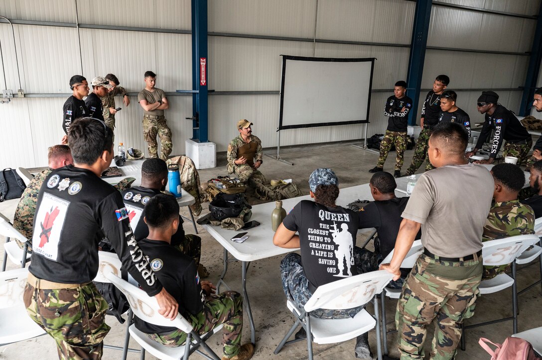 Belize Defence Force and Belize Coast Guard members participate in a tactical combat casualty care class led by U.S. Air Force Tech. Sgt. Daniel Rodriguez, 100th Operation Support Squadron survival, resistance, evasion and escape instructor out of Mildenhall Air Force Base, England, during exercise AGILE BEAR 25, Belize City, Belize, Aug. 4, 2025. Given Central America's high vulnerability to natural disasters, Joint Task Force-Bravo's AGILE BEAR exercise works collaboratively with the British Army Training Support Unit-Belize to equip Belizean forces with the necessary knowledge and resources to lessen the impact of these events. (U.S. Air Force photo by Staff Sgt. Sadie Colbert)