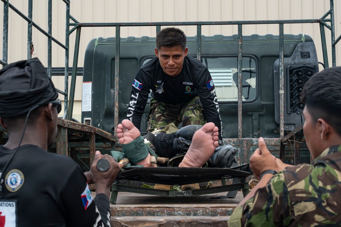 Belize Defence Force members practice loading a patient onto a vehicle during the tactical combat casualty care subject matter expert exchange for AGILE BEAR 25, Belize City, Belize, Aug. 4, 2025. AGILE BEAR, led by Joint Task Force-Bravo provides critical subject matter expert exchanges in disaster response and counter transnational criminal organization activities preparing U.S. Southern Command’s Situational Assessment Team, 1st Battalion, 228th Aviation Regiment, and Belize and NATO partners for a collaborative response in times of crises. (U.S. Air Force photo by Staff Sgt. Sadie Colbert)