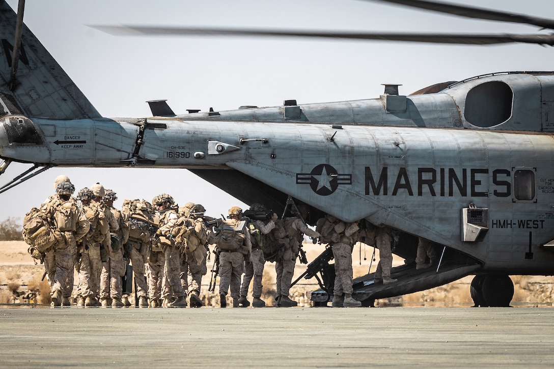 U.S. Marines with 3rd Battalion, 1st Marine Regiment, 1st Marine Division, board a CH-53E Super Stallion assigned to Marine Heavy Helicopter Squadron (HMH) 361, Marine Aircraft Group 16, 3rd Marine Aircraft Wing, during Service Level Training Exercise 4-25 at Marine Corps Air-Ground Combat Center, Twentynine Palms, California,