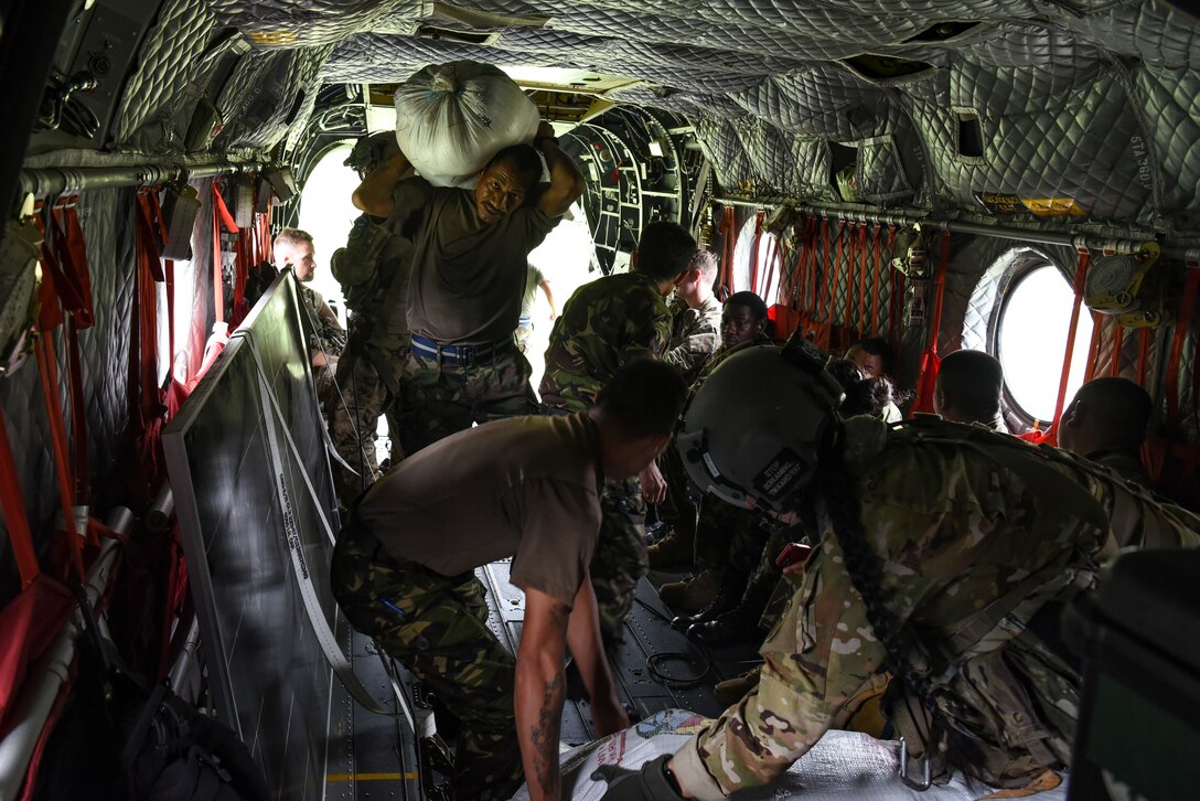 Belize Defence Force (BDF) and British Army Training Support Unit Belize (BATSUB) service members load rations during exercise AGILE BEAR 25, Belize, Aug. 5, 2025. The exercise aims to strengthen the readiness of U.S. and partner nation forces to respond effectively during a disaster and in countering transnational criminal organizations through various subject matter expert exchanges and events. Key participants include Joint Task Force-Bravo, Belize Coast Guard, BDF, U.S. Embassy-Belize, and the BATSUB. (U.S. Air Force photo by Tech. Sgt. Dylan Rossitto)