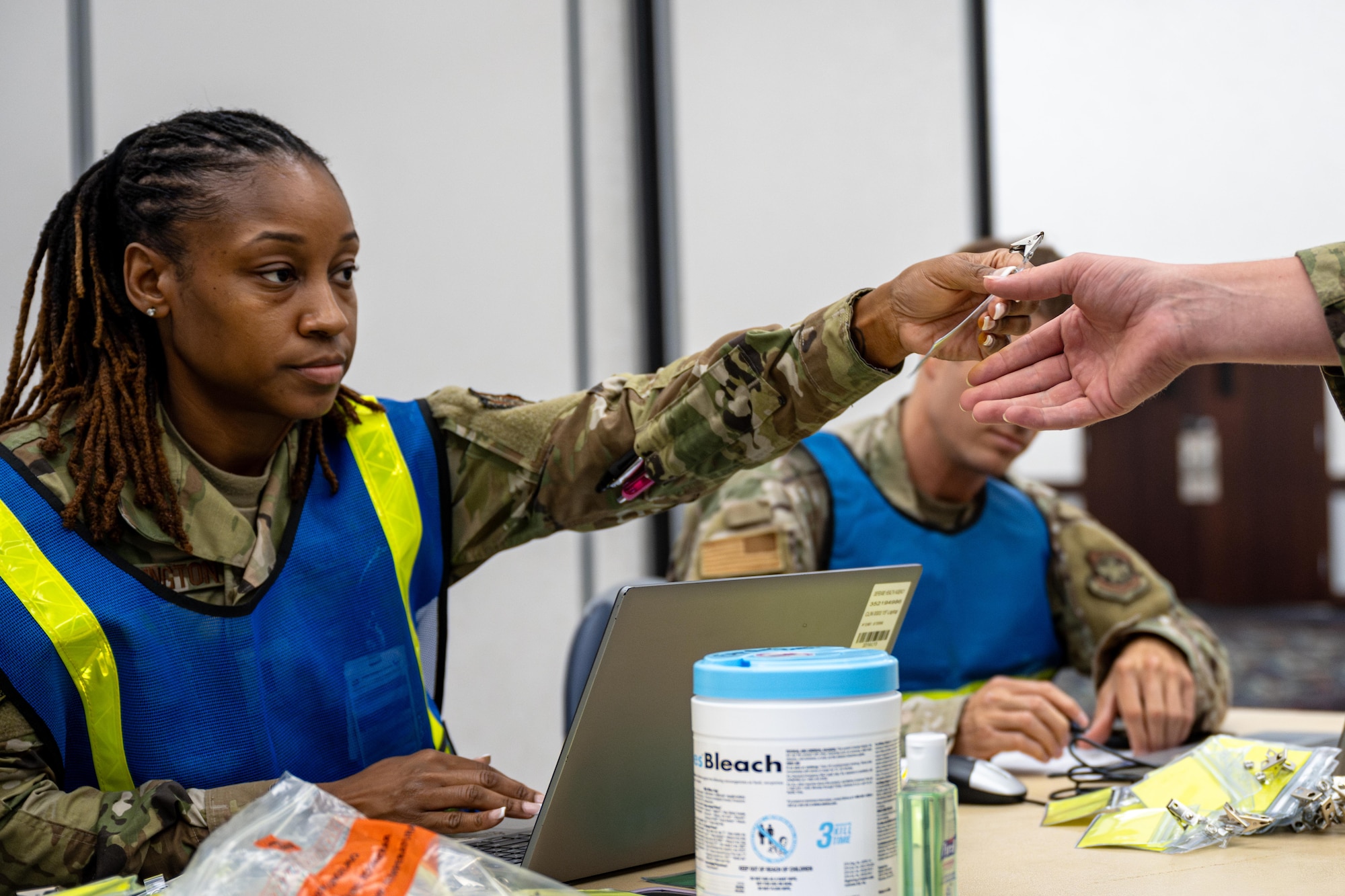 Airman hands out identification cards