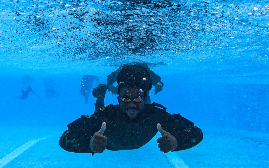 A Belize Defence Force member gives a thumbs up during helocast practice as part of exercise AGILE BEAR 25, Belize City, Belize, Aug. 5, 2025. Helocasting is a technique where personnel jump from a low flying helicopter into a body of water when landing isn’t feasible. As U.S. Southern Command’s rapid response element in Central America, Joint Task Force-Bravo provides a unique and essential capability in enabling our partner nations to proactively confront threats to their security through exercises like AGILE BEAR, which prepare our teams to respond to crises in the joint operational area. (U.S. Air Force photo by Staff Sgt. Sadie Colbert)