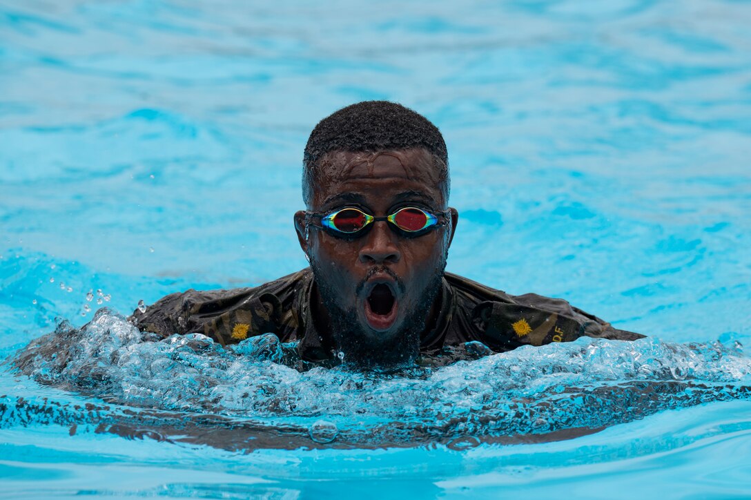 A Belize Defence Force member swims in a pool during helocast practice as part of exercise AGILE BEAR 25, Belize City, Belize, Aug. 5, 2025. Helocasting is a technique where personnel jump from a low flying helicopter into a body of water when landing isn’t feasible. As U.S. Southern Command’s rapid response element in Central America, Joint Task Force-Bravo provides a unique and essential capability in enabling our partner nations to proactively confront threats to their security through exercises like AGILE BEAR, which prepare our teams to respond to crises in the joint operational area. (U.S. Air Force photo by Staff Sgt. Sadie Colbert)
