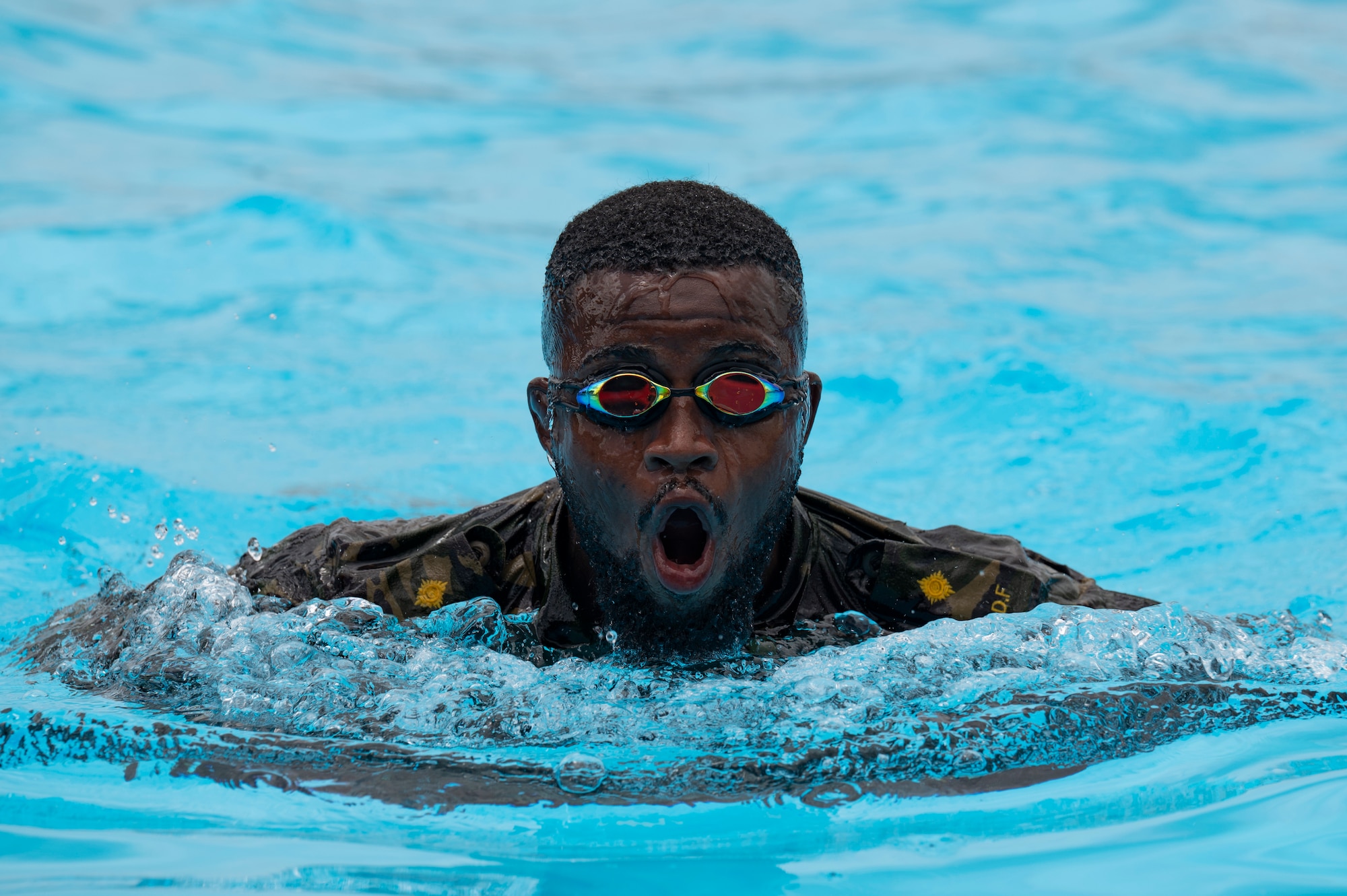 A Belize Defence Force member swims in a pool during helocast practice as part of exercise AGILE BEAR 25, Belize City, Belize, Aug. 5, 2025. Helocasting is a technique where personnel jump from a low flying helicopter into a body of water when landing isn’t feasible. As U.S. Southern Command’s rapid response element in Central America, Joint Task Force-Bravo provides a unique and essential capability in enabling our partner nations to proactively confront threats to their security through exercises like AGILE BEAR, which prepare our teams to respond to crises in the joint operational area. (U.S. Air Force photo by Staff Sgt. Sadie Colbert)