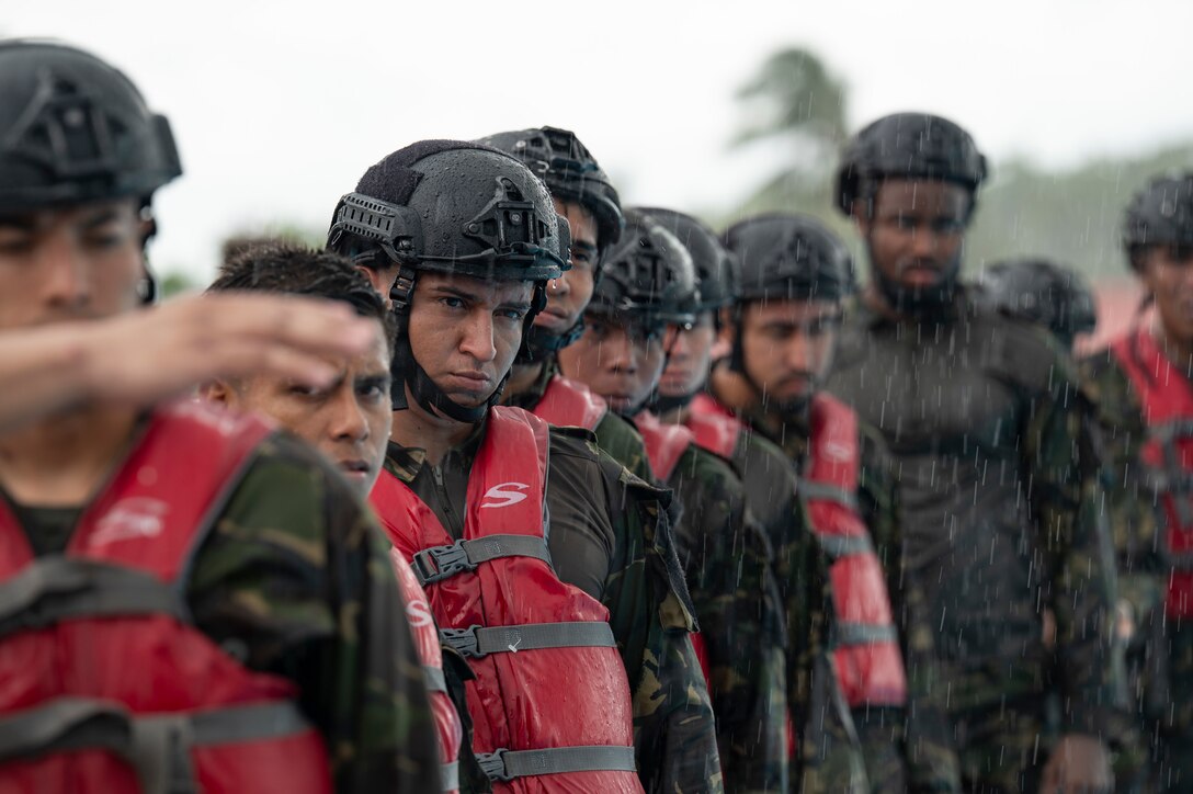Belize Defence Force members wait in line for helocast practice during AGILE BEAR 25, at Belize City, Belize, Aug. 5, 2025. Helocasting is a technique where personnel jump from a low flying helicopter into a body of water when traditional landing isn’t feasible. As U.S. Southern Command’s rapid response element in Central America, Joint Task Force-Bravo provides a unique and essential capability in enabling our partner nations to proactively confront threats to their security through exercises like AGILE BEAR, which prepare our teams to respond to crises in the joint operational area. (U.S. Air Force photo by Staff Sgt. Sadie Colbert)