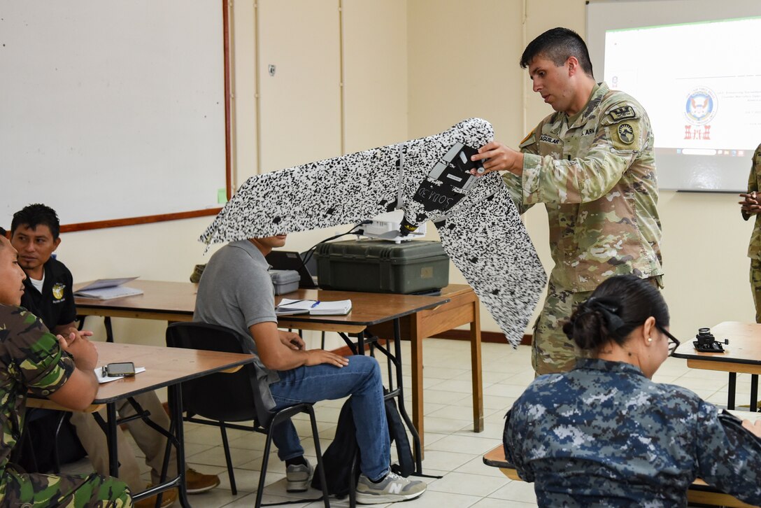 U.S. Army 1st Lt. Jacob Aguilar, Joint Task Force-Bravo J7 engineering project officer, explains parts of a small, unmanned aircraft system (sUAS) during exercise AGILE BEAR 25, Belize City, Belize, Aug. 4, 2025. AGILE BEAR, led by JTF-Bravo provides critical subject matter expert exchanges in disaster response and counter transnational criminal organization activities preparing U.S. Southern Command’s Situational Assessment Team, 1st Battalion, 228th Aviation Regiment, and Belize and NATO partners for a collaborative response in times of crises. (U.S. Air Force photo by Tech. Sgt. Dylan Rossitto)