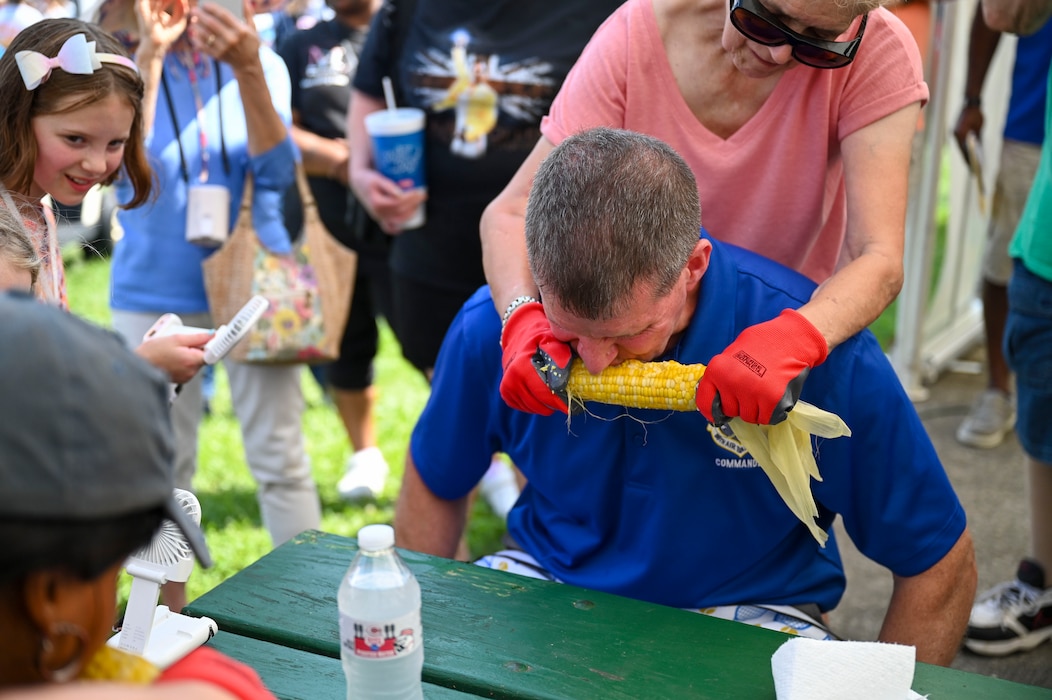 Col. Dustin Richards, 88th Air Base Wing and installation commander, competes in a corn eating contest.