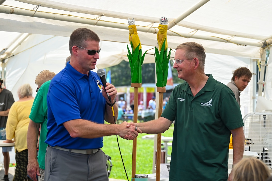 Col. Dustin Richards, 88th Air Base Wing and installation commander, and Dan Kirkpatrick, City of Fairborn Mayor, shake hands.