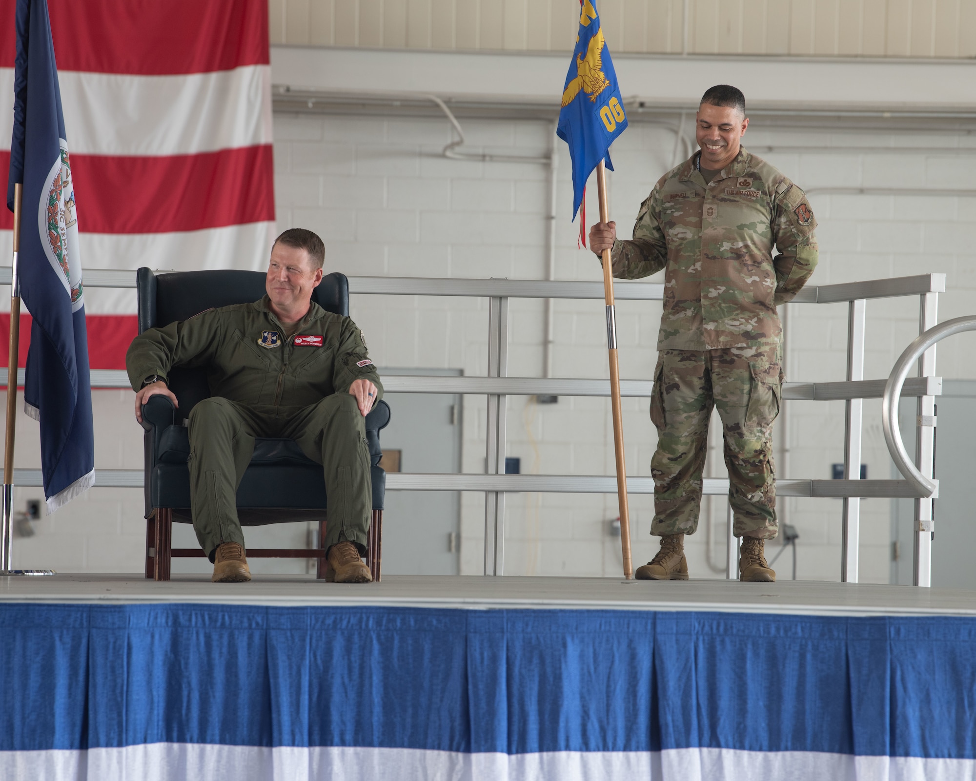 Lt. Col. Matthew B. Woodfield, newly appointed 192nd Operations Group commander, and Chief Master Sgt. Karl L. Burnell, 192nd OG senior enlisted leader smile on stage