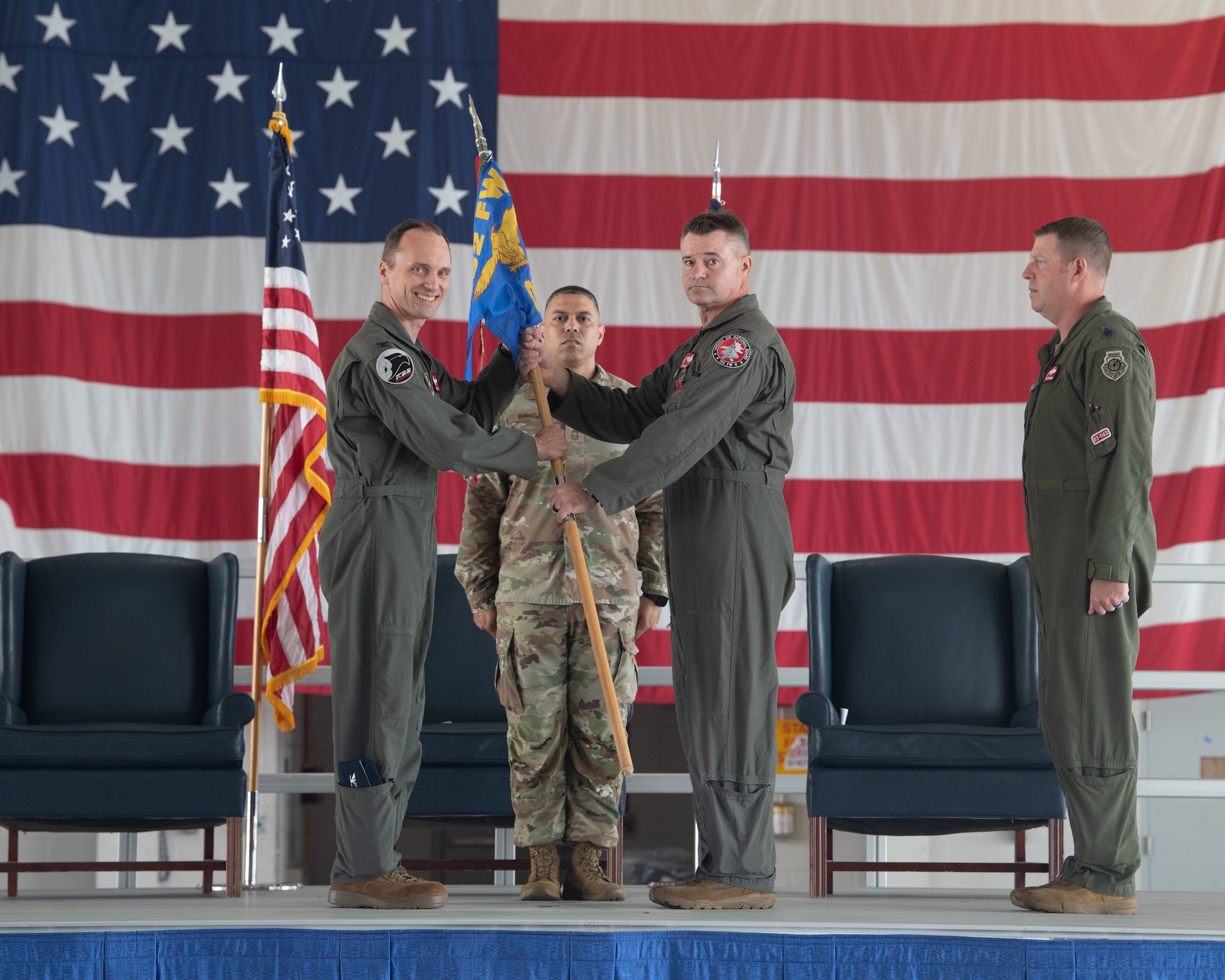 Col. Andrew M. Weidner, center, outgoing 192nd Operations Group commander, passes the 192nd OG guidon to Col. Brock E. Lange, 192nd Wing commander