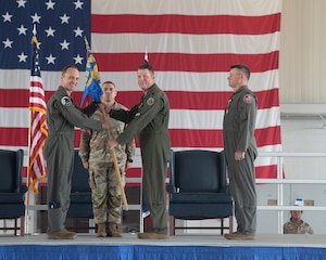 Col. Brock E. Lange, left, 192nd Wing commander, passes the 192nd Operations Group guidon to Lt. Col. Matthew B. Woodfield