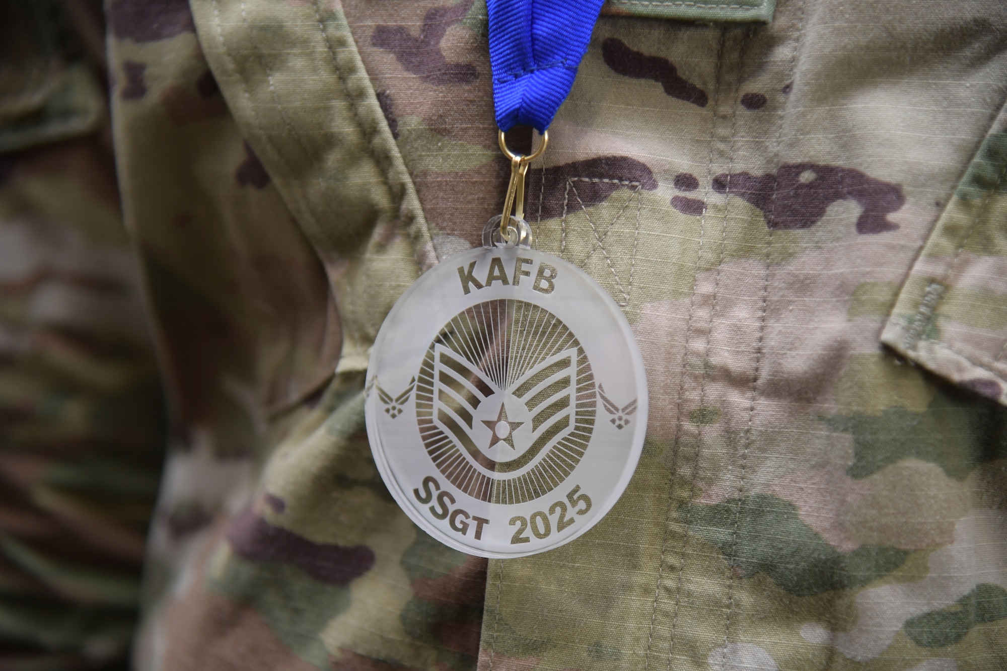 A staff sergeant emblem is on display around a military member's neck.