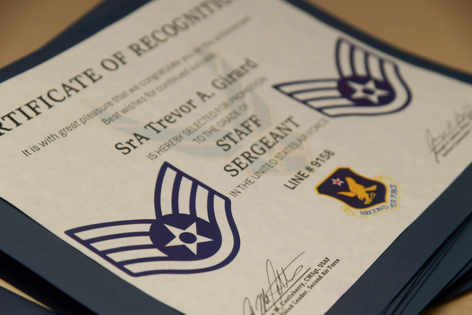 A staff sergeant certificate is on display.