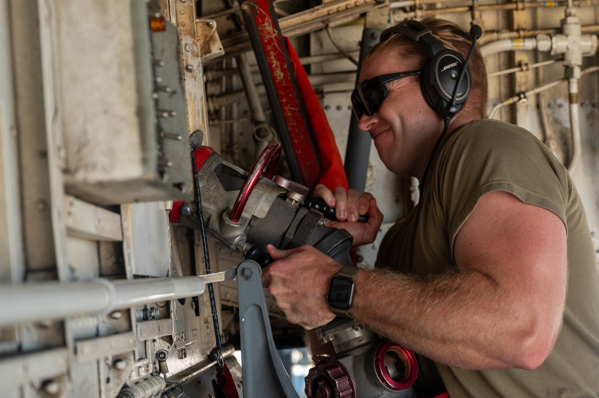 U.S. Air Force Senior Airman Alex Bengel, 350th Air Refueling Squadron boom operator, connects a fuel hose to a KC-135 Stratotanker aircraft at McConnell Air Force Base, Kansas, July 8, 2025. While ground fueling is typically conducted by logistics Airmen, boom operators were instructed on fueling and basic maintenance procedures as they provided critical air refueling support to the Air Force's 2025 Department-Level Exercise series. The DLE series encompasses all branches of the Department of Defense, along with Allies and partners, employing more than 400 Joint and coalition aircraft and more than 12,000 members at more than 50 locations across 3,000 miles (U.S. Air Force photo by Tech. Sgt. Nathan Eckert)